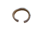 Antique African bronze cuff bracelet with a raised stripe design and time-softened patina.