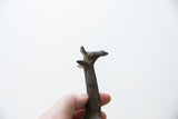 Aged patina and sculpted details on the head of a vintage bronze giraffe.