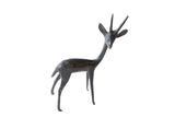 Vintage right facing African gazelle figurine, dark metal with aged patina.