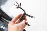 Stylized dark metal hind legs and body of the vintage African gazelle.