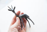 Dark metallic body and slender legs of the vintage African gazelle figurine.