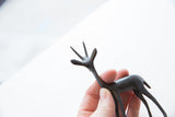 Vintage African gazelle sculpture close-up, featuring its dark textured head and antlers.