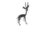 Vintage right-facing African gazelle figurine with a stylized form and dark patina.