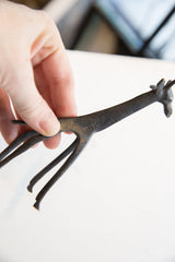 Vintage dark bronze African giraffe with intricate patterns and aged patina on its neck.