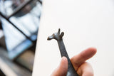 Close-up of the vintage bronze giraffe's head and textured neck.