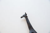 Vintage dark bronze giraffe head with textured neck details.