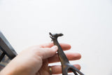 Vintage dark bronze African giraffe head with patterned neck detail.