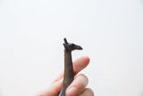 Profile view showing the sculpted head of the vintage bronze giraffe figurine.
