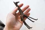 Vintage dark bronze giraffe close-up detailing textured body and patterned neck.