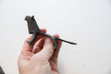 Side profile of the vintage African lion with dark textured patina.