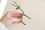 Vintage African gazelle figurine's lower body and slender legs with green-brown patina.