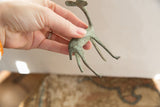 Oxidized vintage gazelle figurine showing the detail of its broken back foot and patina.