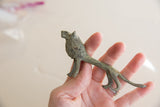 Profile view of the vintage African lion collectible, showing its aged, oxidized metal texture.