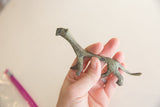 Vintage African lioness figurine with an oxidized finish held in hand for scale.