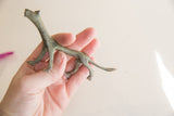 Vintage African cheetah figurine with oxidized patina shown in hand for scale.