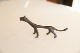 Side profile of the vintage African cheetah's slender form and dark patina.