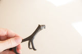 Textured dark patina on the head and neck of a vintage cheetah figurine.