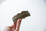 Profile of the vintage African cuff's scalloped edge and textured rope design.