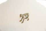 Vintage African bronze monkey figure showing textured green-brown patina.