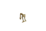 Vintage African bronze monkey statuette holding a fish with a weathered, textured patina.
