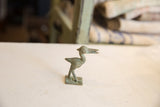 Vintage African bronze bird sculpture in profile, showing its stylized long-legged form and patina.