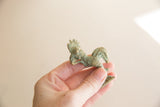 Vintage African bronze rooster held in hand to show its small scale and details.