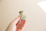Textured patina on the square base of the vintage bronze rooster.