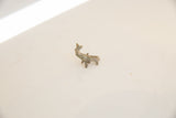 Angled view highlighting the vintage patina on a tiny elephant collectible.