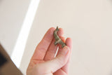 Tiny vintage African elephant collectible held in hand, showing its scale and patina.