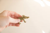 Vintage African bronze boar figurine held to demonstrate its small, collectible size.