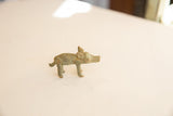 Side profile of a vintage African pig gold weight showing its rustic, aged patina.