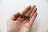 Vintage African mini hippo collectible held in hand to demonstrate its small scale.
