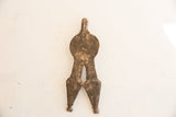Aged patina and rustic, uneven texture on the reverse of the snake pendant.