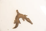 Stylized vintage African crocodile pendant with a rough, oxidized metal surface.