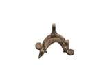 Arched vintage African pendant in aged cast metal with etched details and spiral motifs.