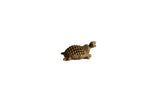 Vintage African bronze turtle pendant with a detailed lattice-patterned shell.