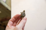 The detailed shell and small scale of the vintage African bronze turtle pendant.