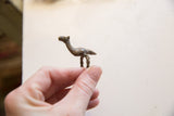 A vintage bronze ring showing the full side profile of the camel figure.