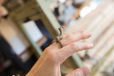Vintage bronze camel ring worn on a finger to show its scale and textured fit.