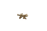 Vintage African bronze frog pendant with a rustic textured surface and curled tail.