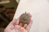 The back of the vintage African bronze pendant showing its textured surface and loops.