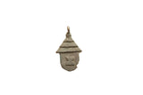Vintage African bronze hut pendant with a textured conical roof and etched details.