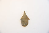 Flat reverse side of the vintage African bronze pendant showing a weathered, textured patina.
