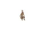 Vintage African monkey pendant in a sitting pose with an aged metal finish.