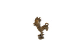Vintage African rooster pendant with an aged bronze patina and stylized coiled details.