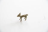 The vintage African impala ram pendant's stylized profile and aged metal finish.