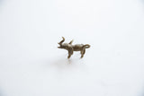 Three-quarter view of the small bronze elephant pendant showing its textured, aged patina.