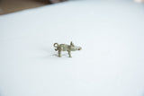 Angled profile of the vintage bronze boar pendant showing its textured back and curly tail.