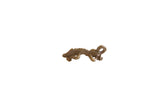 Vintage African bronze iguana pendant with a detailed, textured surface and curled tail.