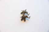 Two vintage African bronze elephant pendants with rustic patina shown together.